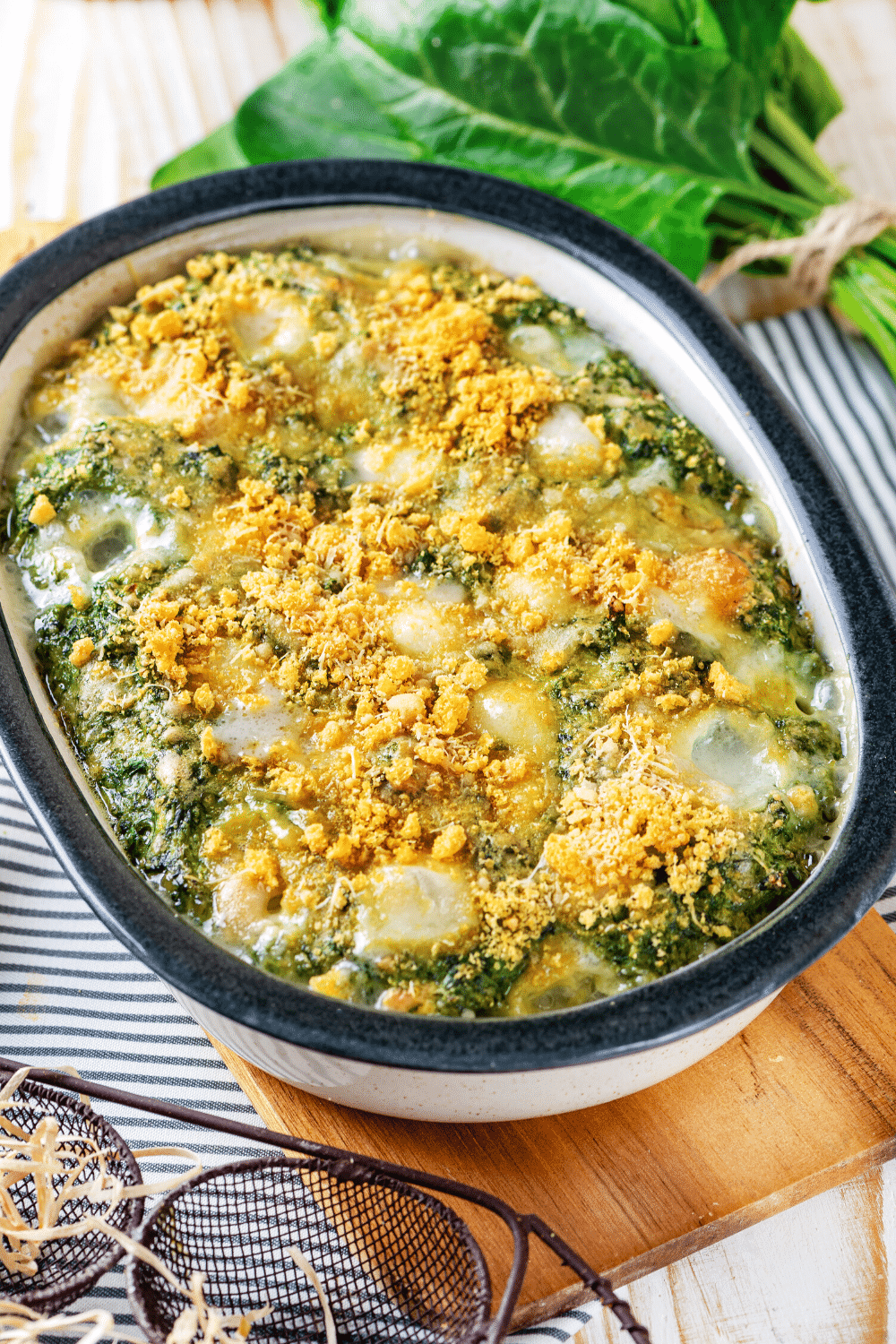 A baking dish with spinach casserole in it