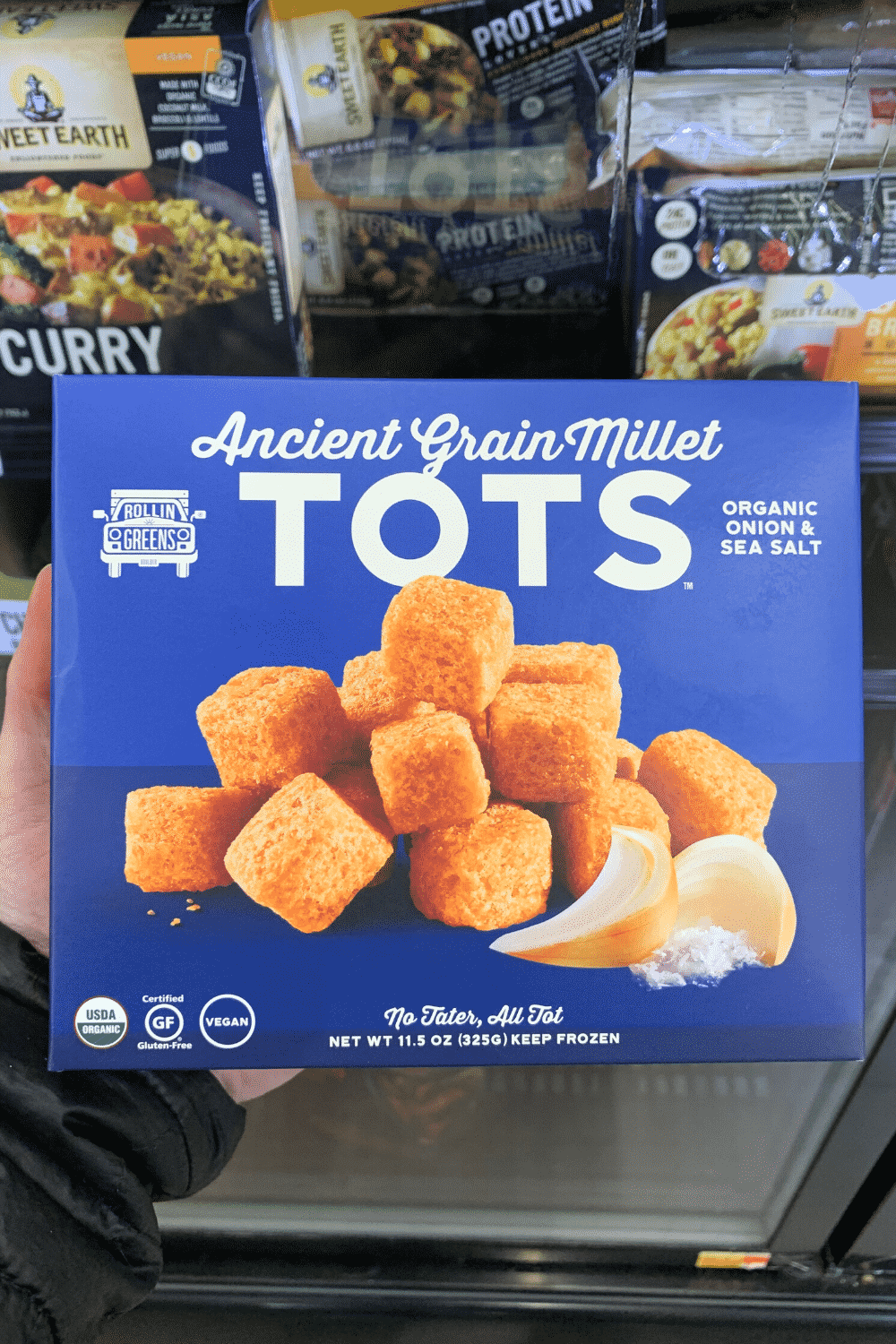 A hand holding ancient grain millet tots.