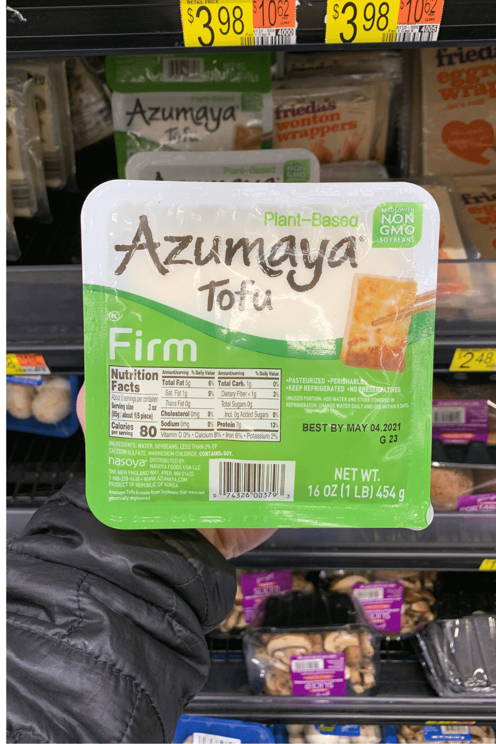 A hand holding Azumaya tofu.