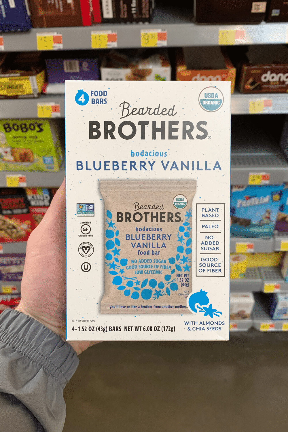 A hand holding Bearded brothers bodacious blueberry vanilla bars.