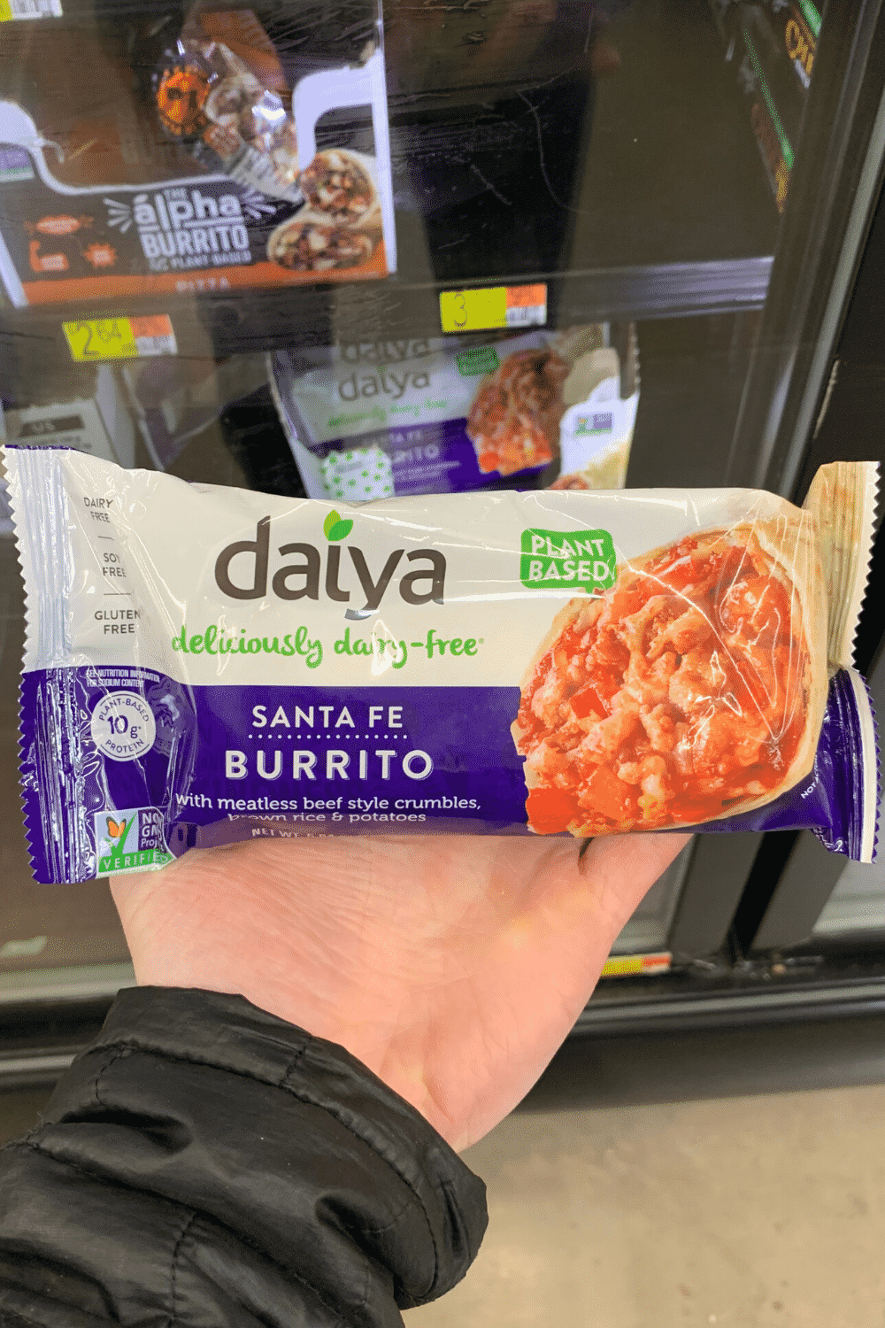 A hand holding Daiya Santa Fe burrito.