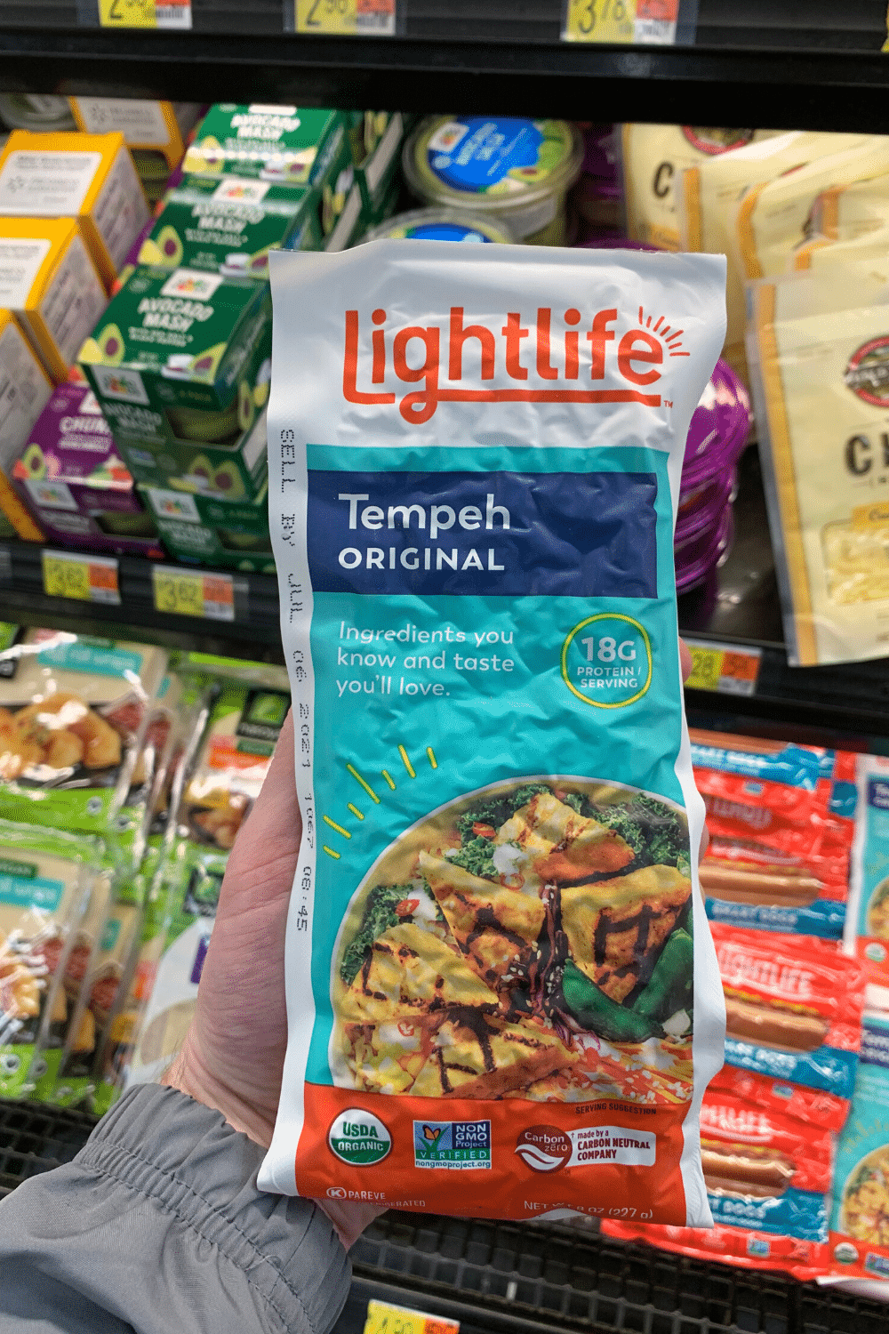 A hand holding the light life tempeh original.