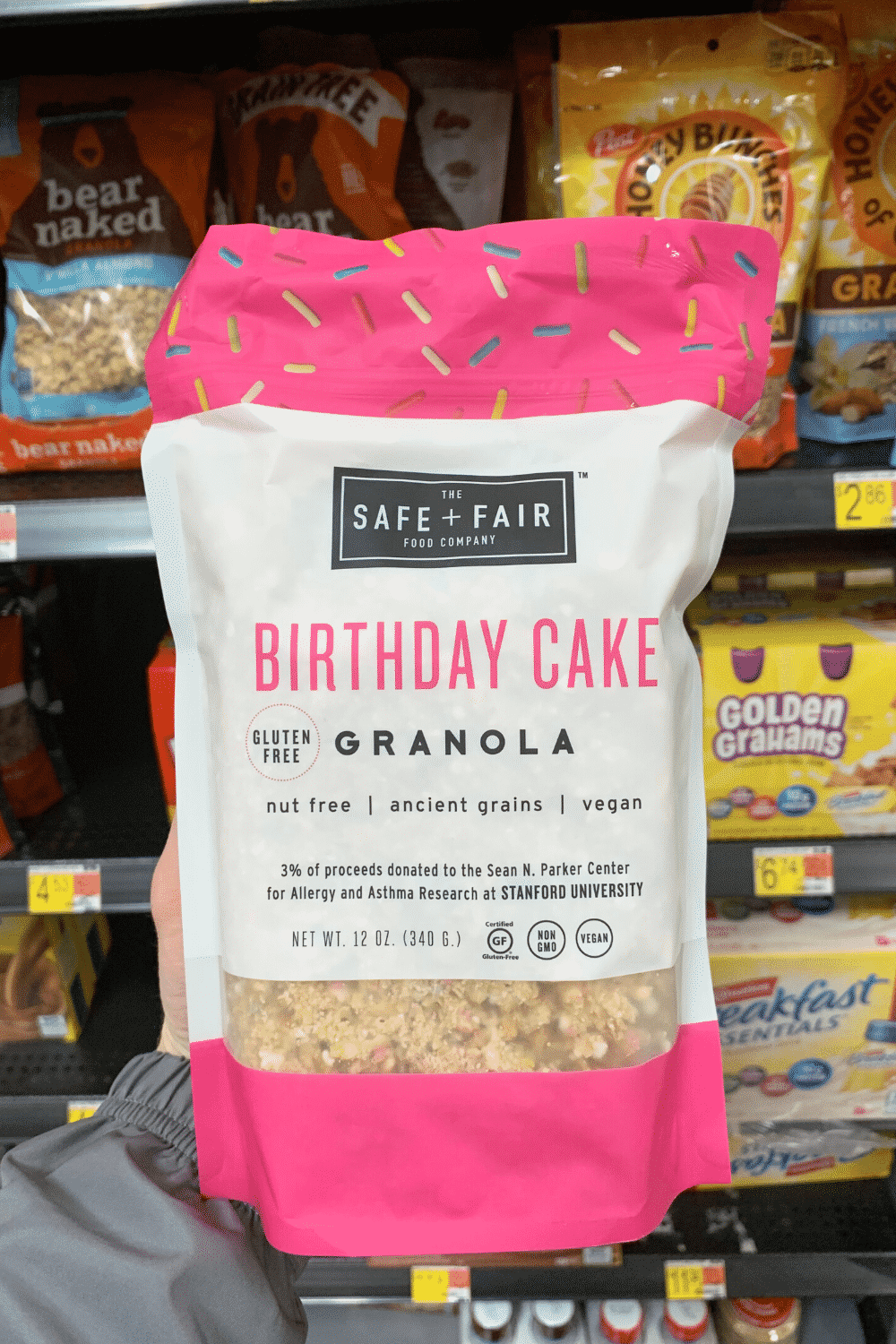 A hand holding safe plus fair food company birthday cake cake granola.