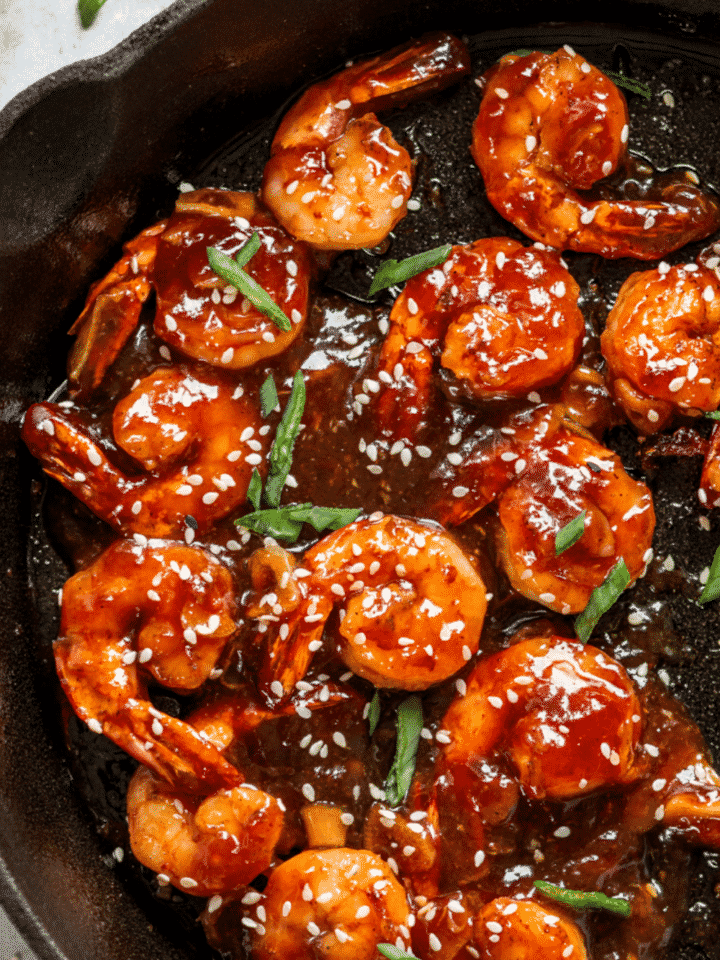 A bunch of sweet and sour shrimp in a skillet.