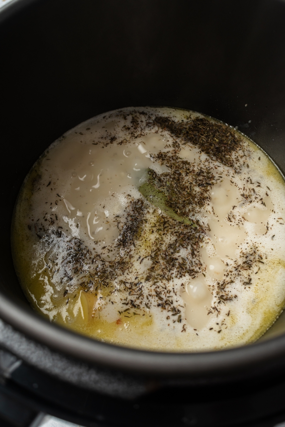An instant pot filled with clam chowder ingredients.