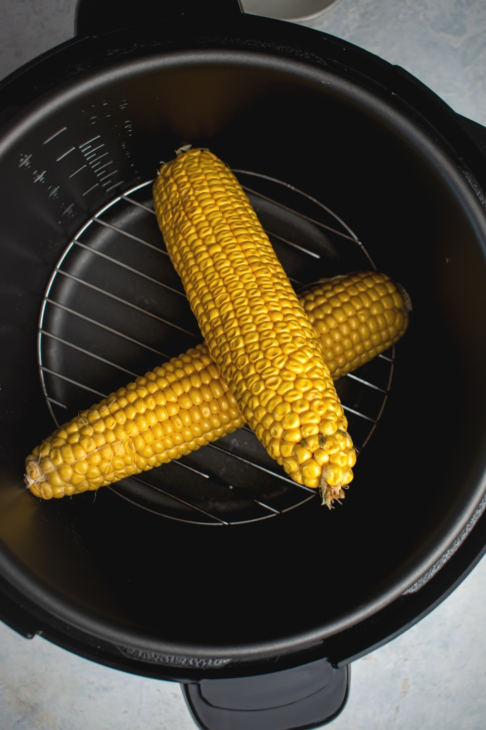 Two corn on the carbs in an instant pot.