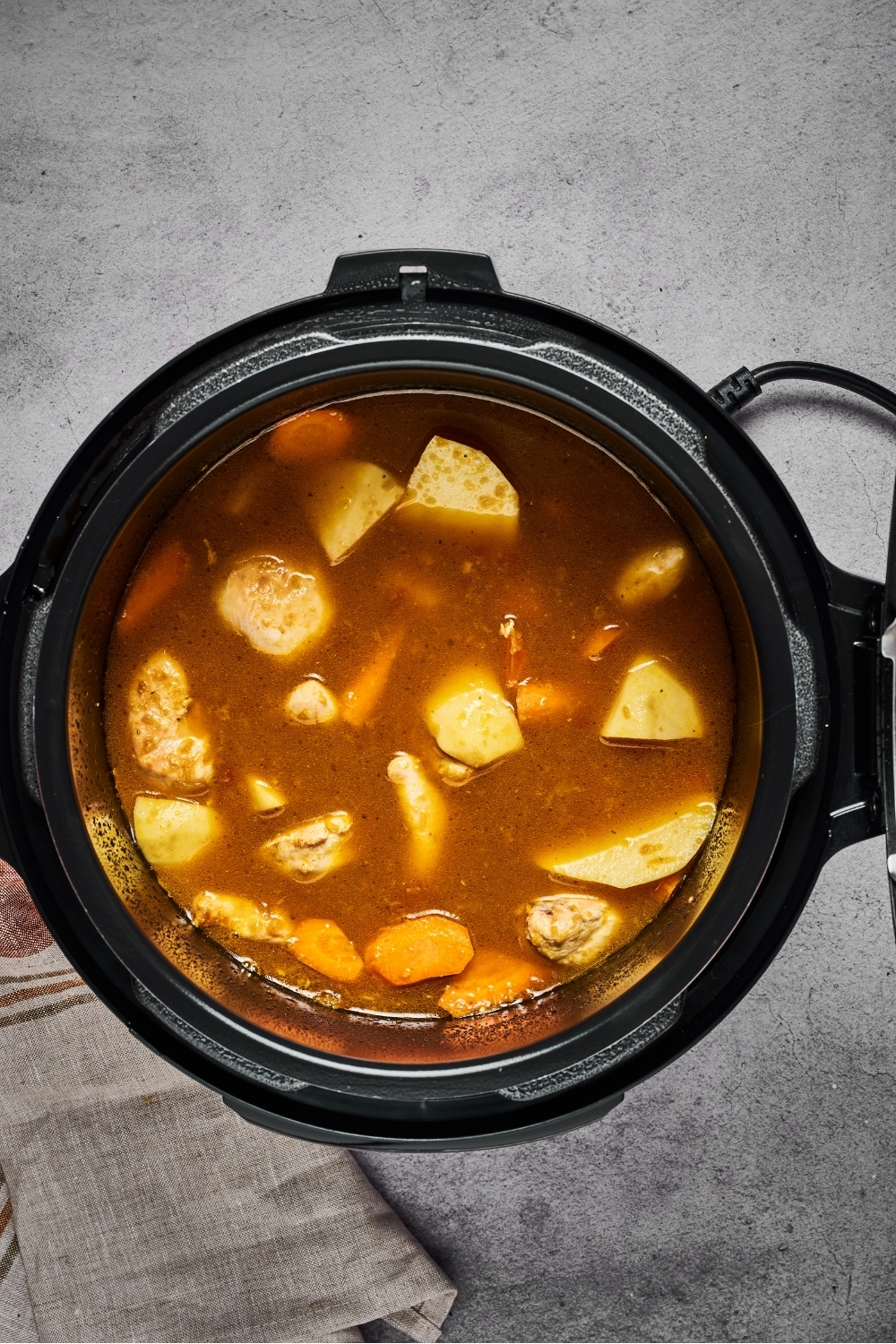 An instant pot with Japanese curry ingredients in it.