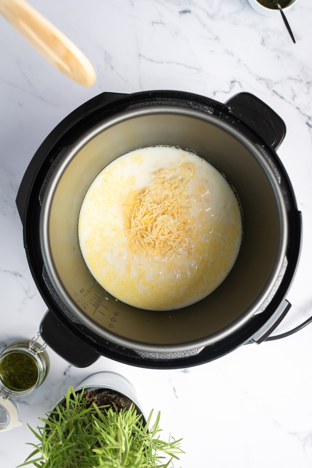 An instant pot filled with creamy polenta ingredients.