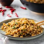 A plate with egg fried rice on it.