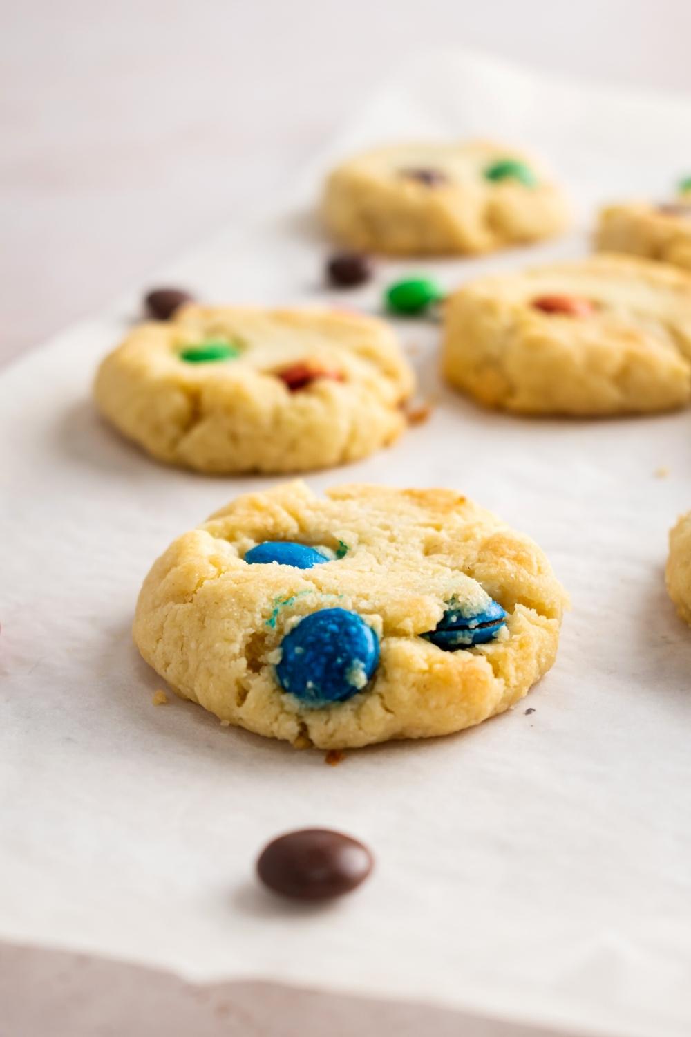 A bunch of three ingredient sugar cookies on a piece of parchment paper.