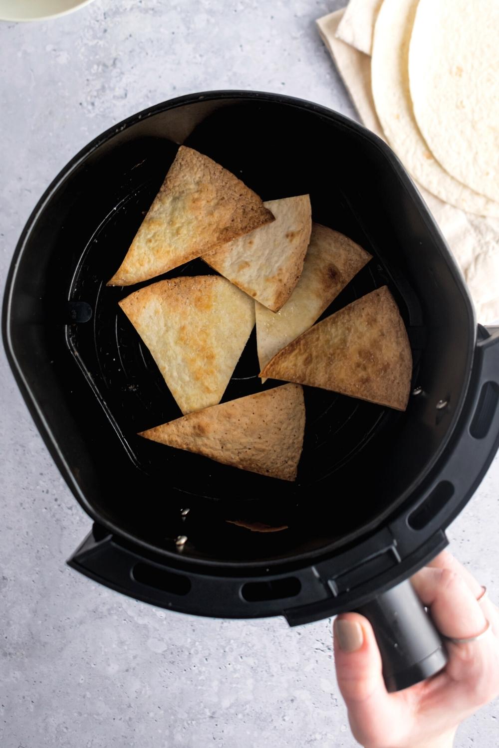 A couple of air fryer tortilla chips in an air fryer.