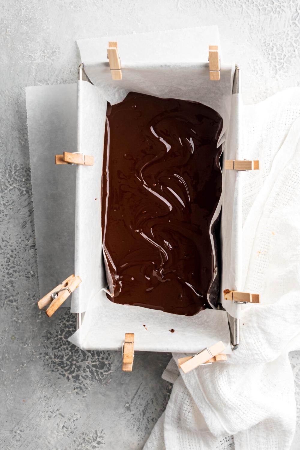 Melted Nutella fudge in a rectangular pan lined with parchment paper.