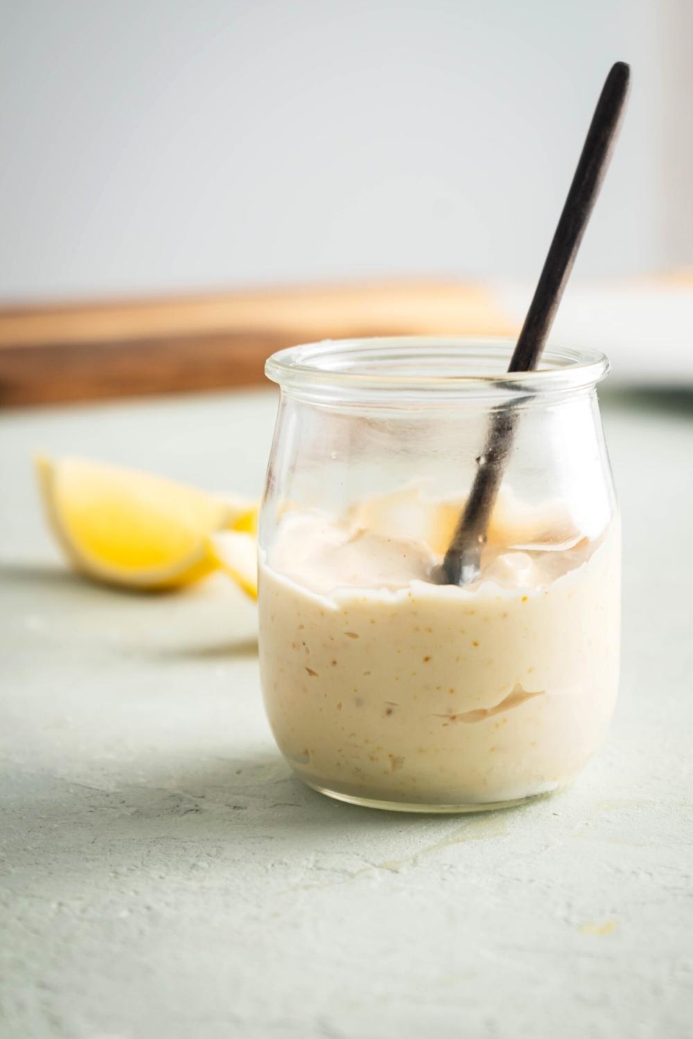 A glass jar that is filled with chipotle mayo.