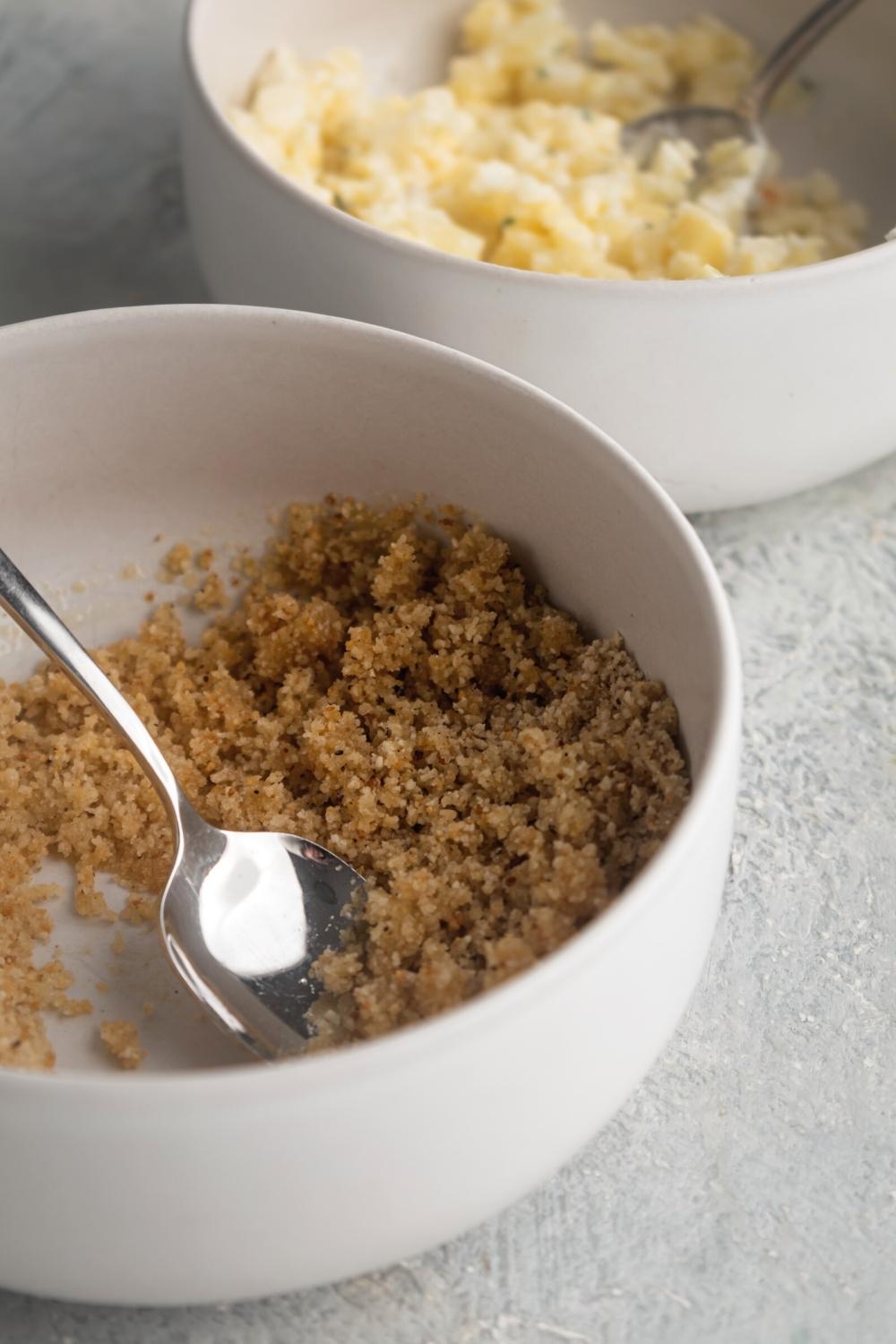 Part of a white bowl with breadcrumbs.