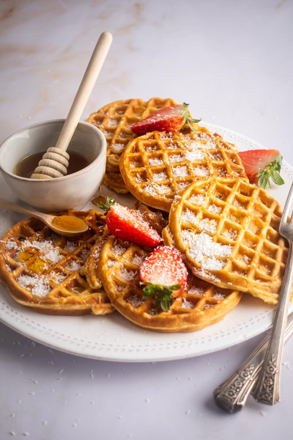 How are you play with a bunch of waffles on it and a bowl with honey in it.