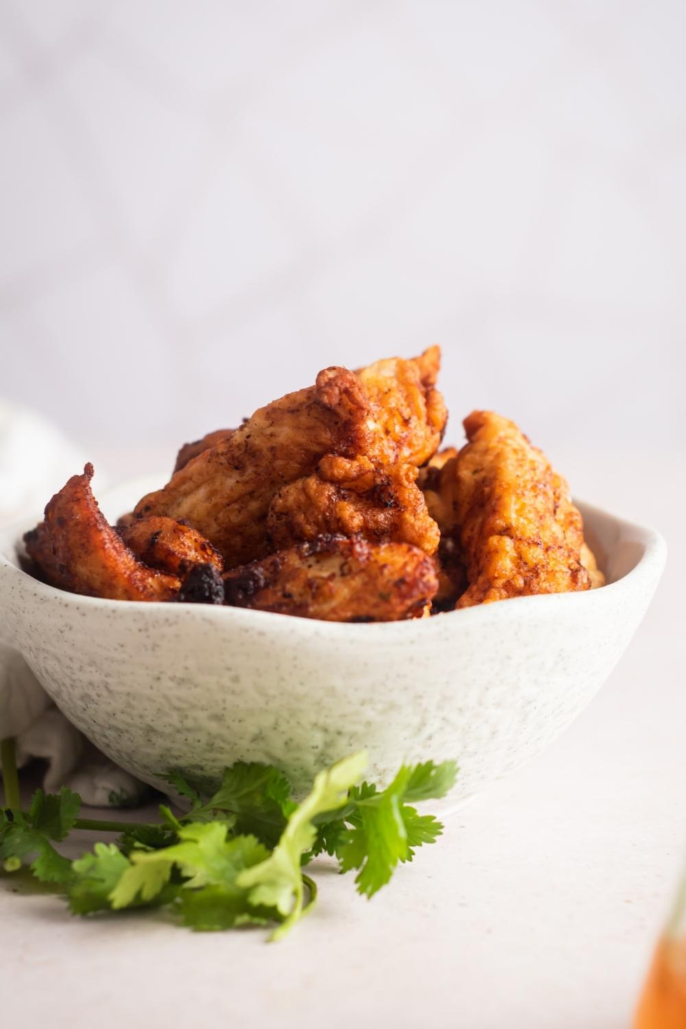 A close up of a bowl piled high with Mar Far chicken