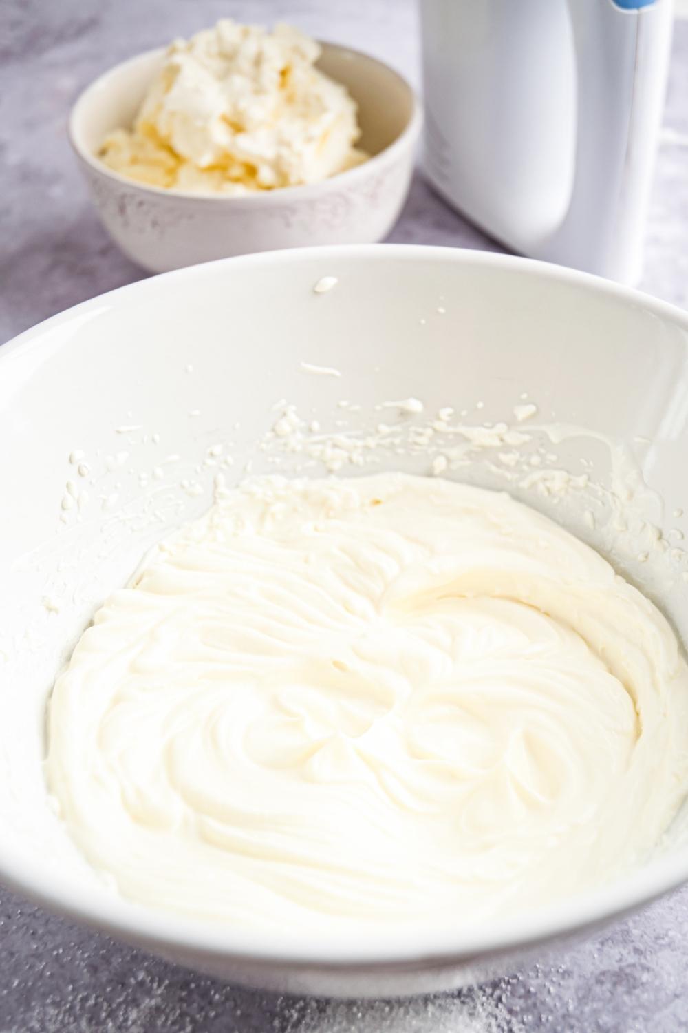 A close-up of a large bowl with homemade whipped cream in it.