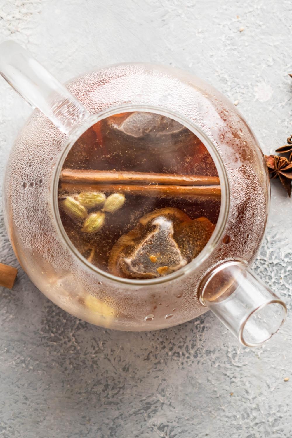 A glass pitcher filled with thai tea.