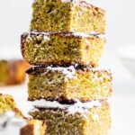 Four matcha brownies stacked on top of one another.