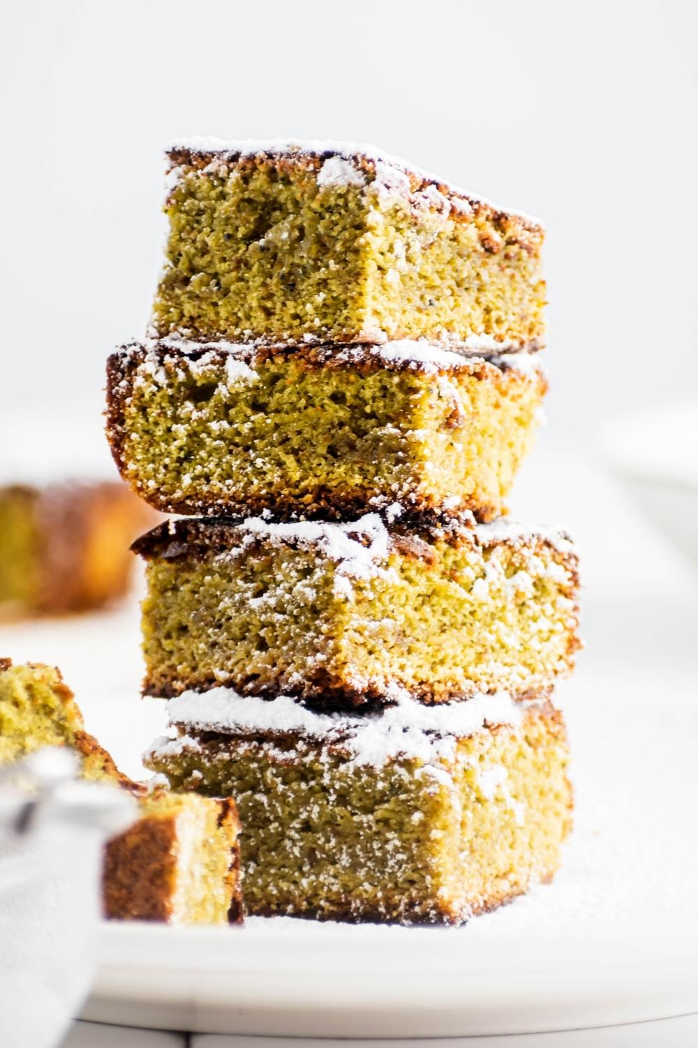 Four matcha brownies stacked on top of one another.