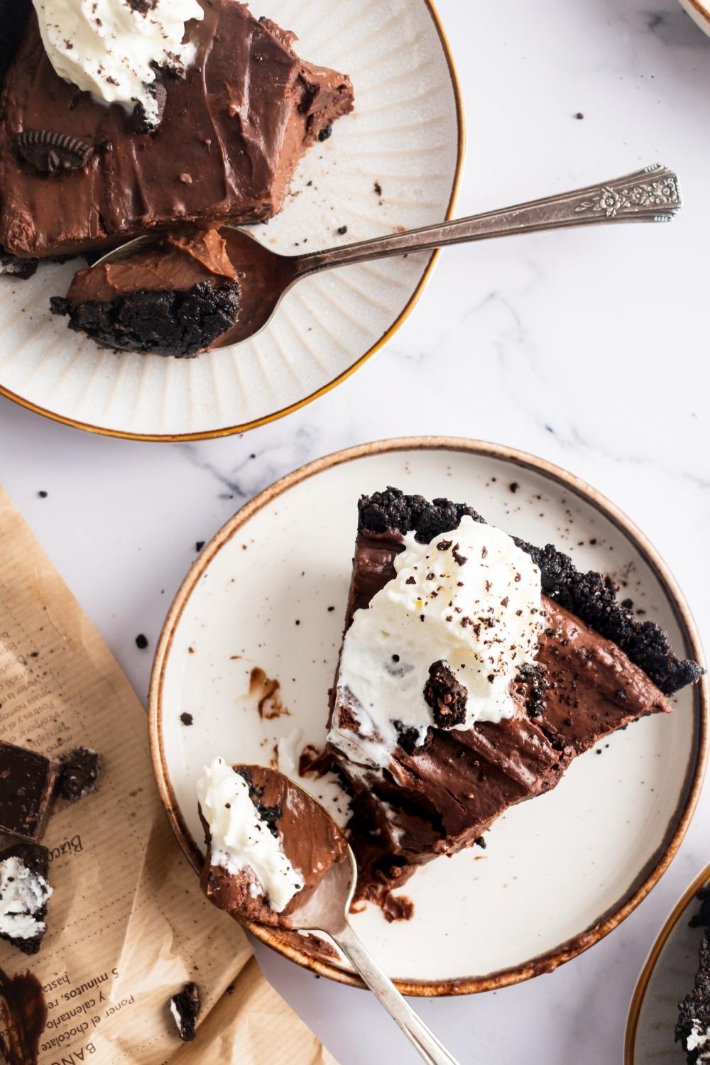 Two slices of mississippi mud pie on individual plates.