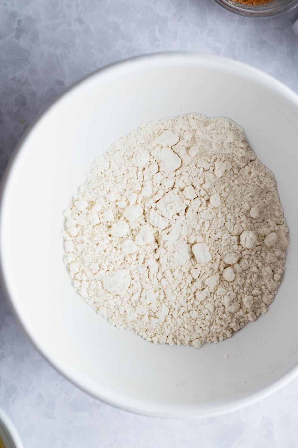 An overhead view of a mixing bowl with heat treated flour.