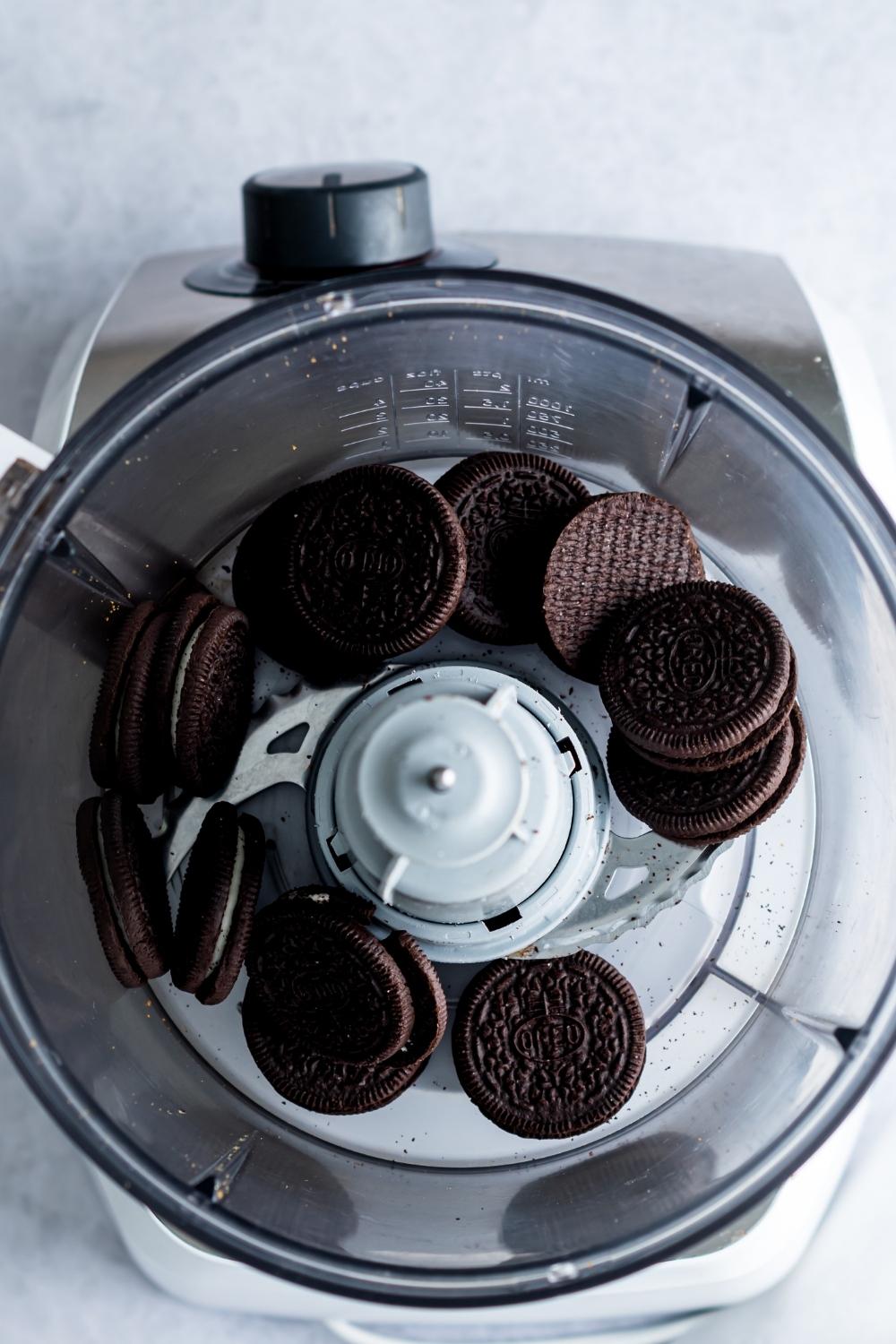 An overhead view of oreos in a food processor.