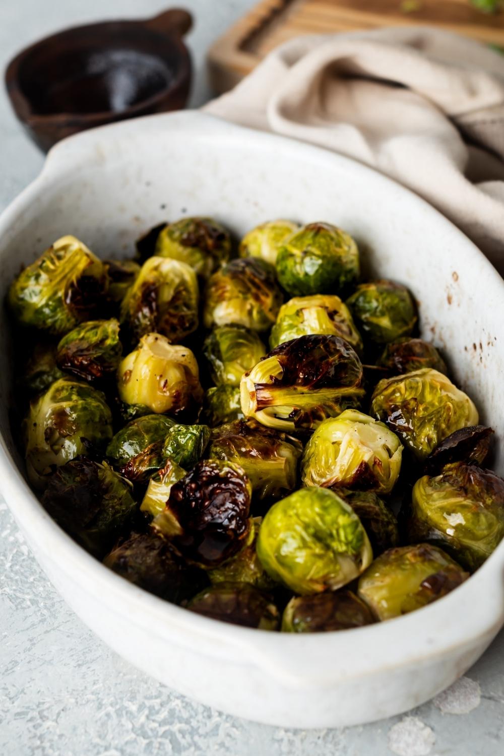 A casserole dish with cooked brussels sprouts.