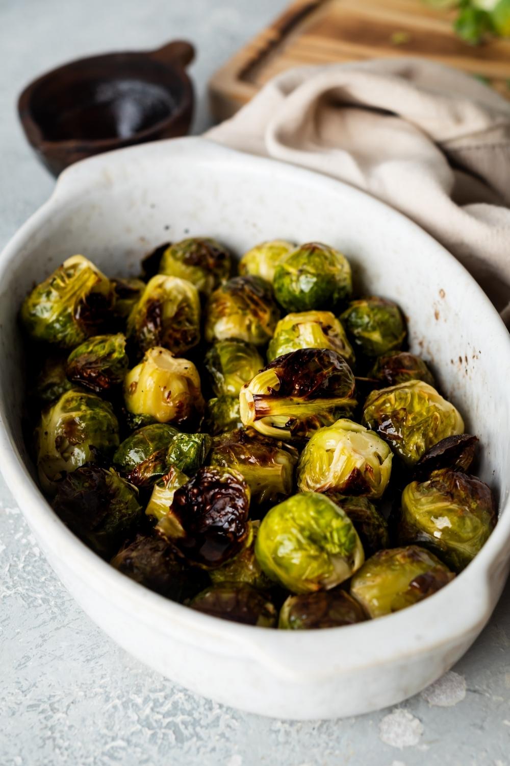 A casserole dish with cooked brussels sprouts.