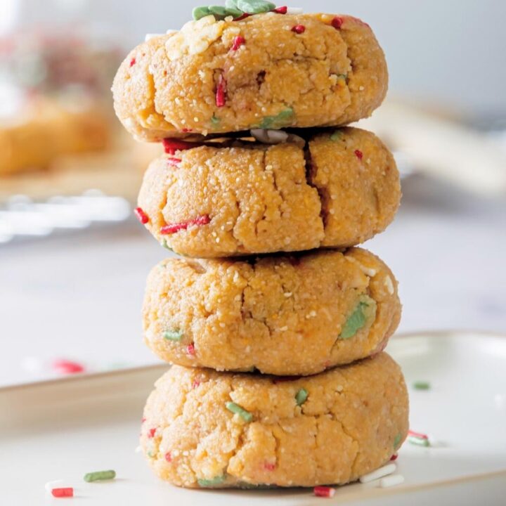 Four no bake christmas cookies stacked on top of one another.