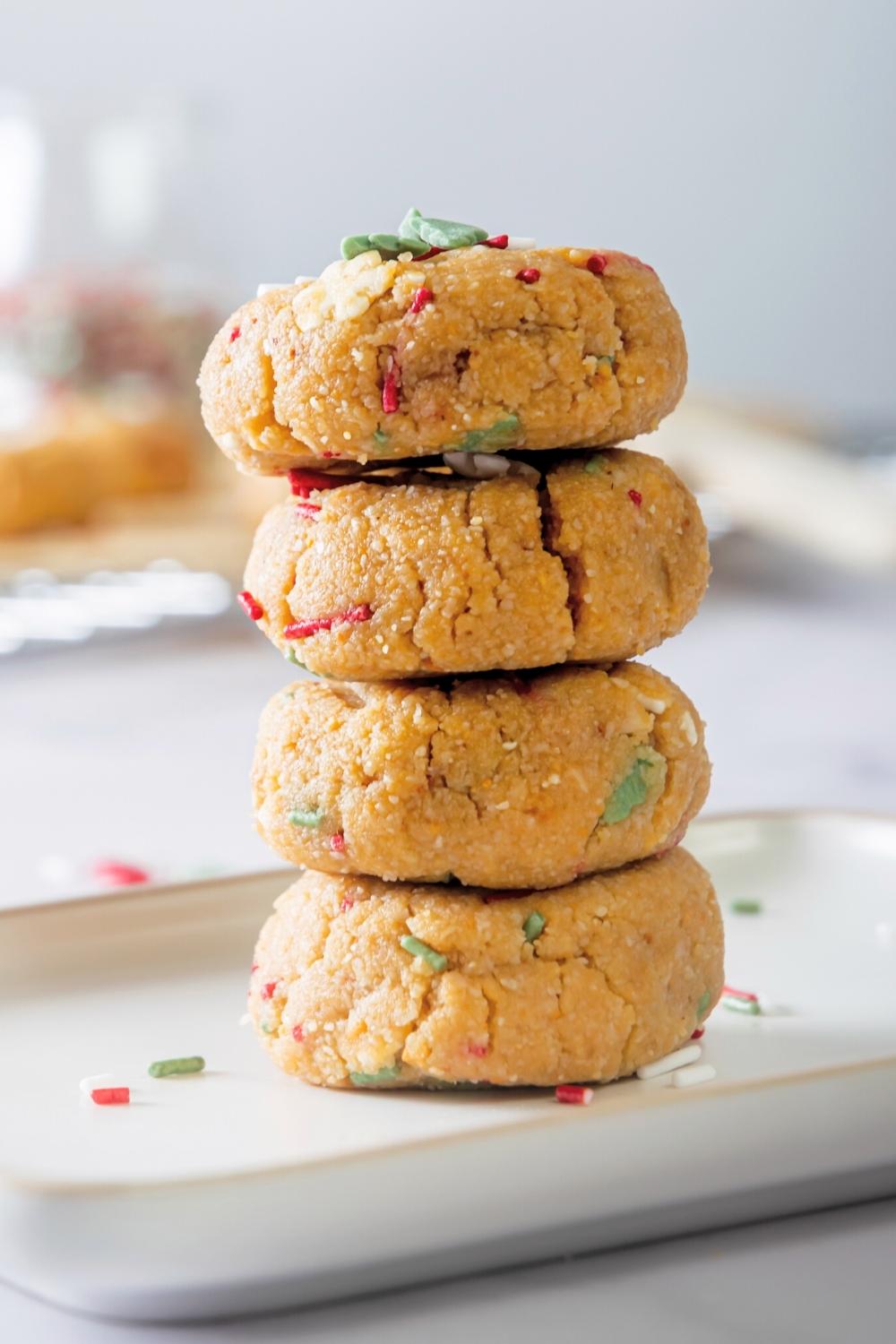 Four no bake christmas cookies stacked on top of one another.