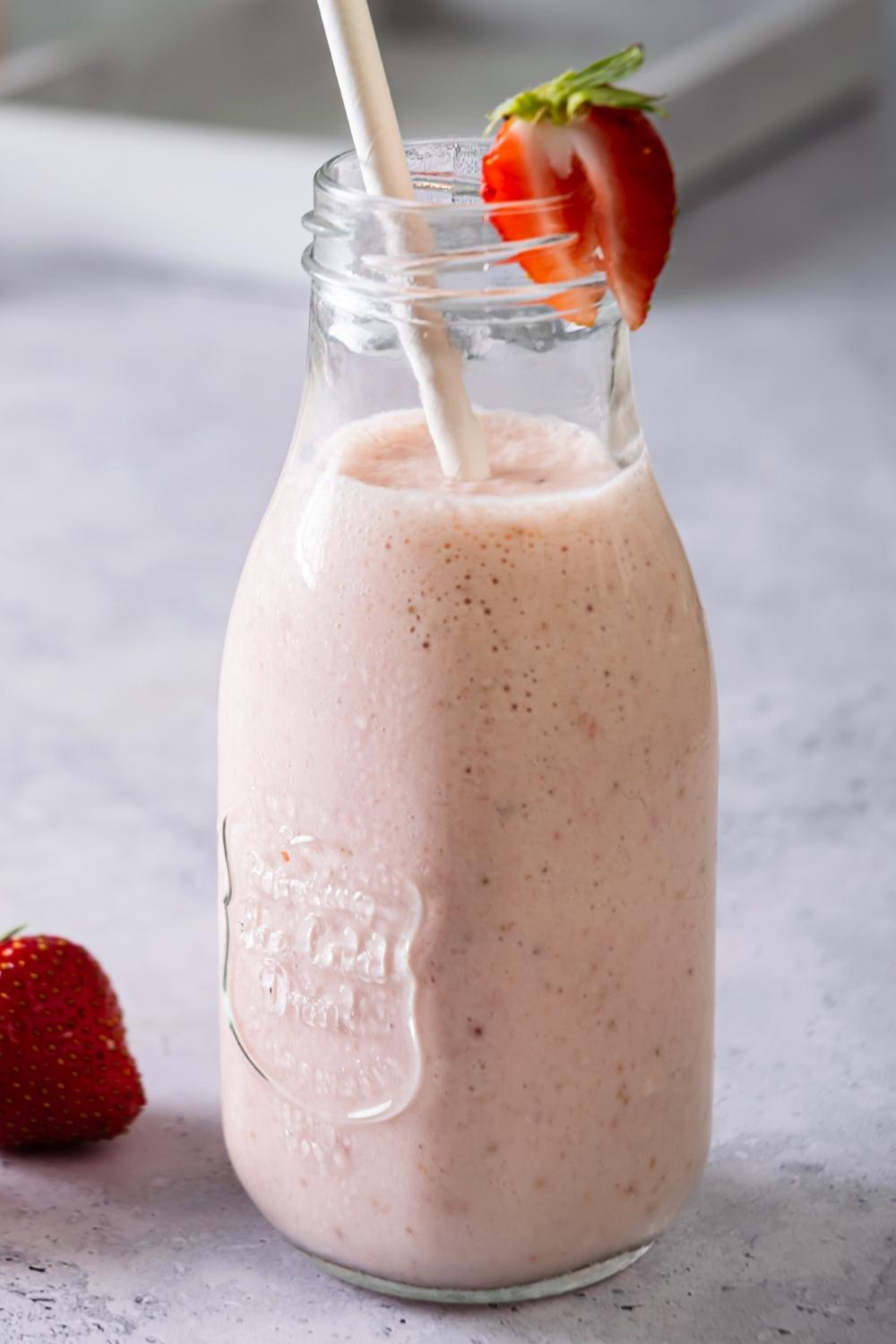 A glass filled with a strawberry banana smoothie.