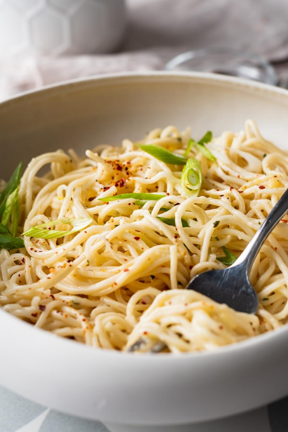 close up of cheesy ramen with a fork