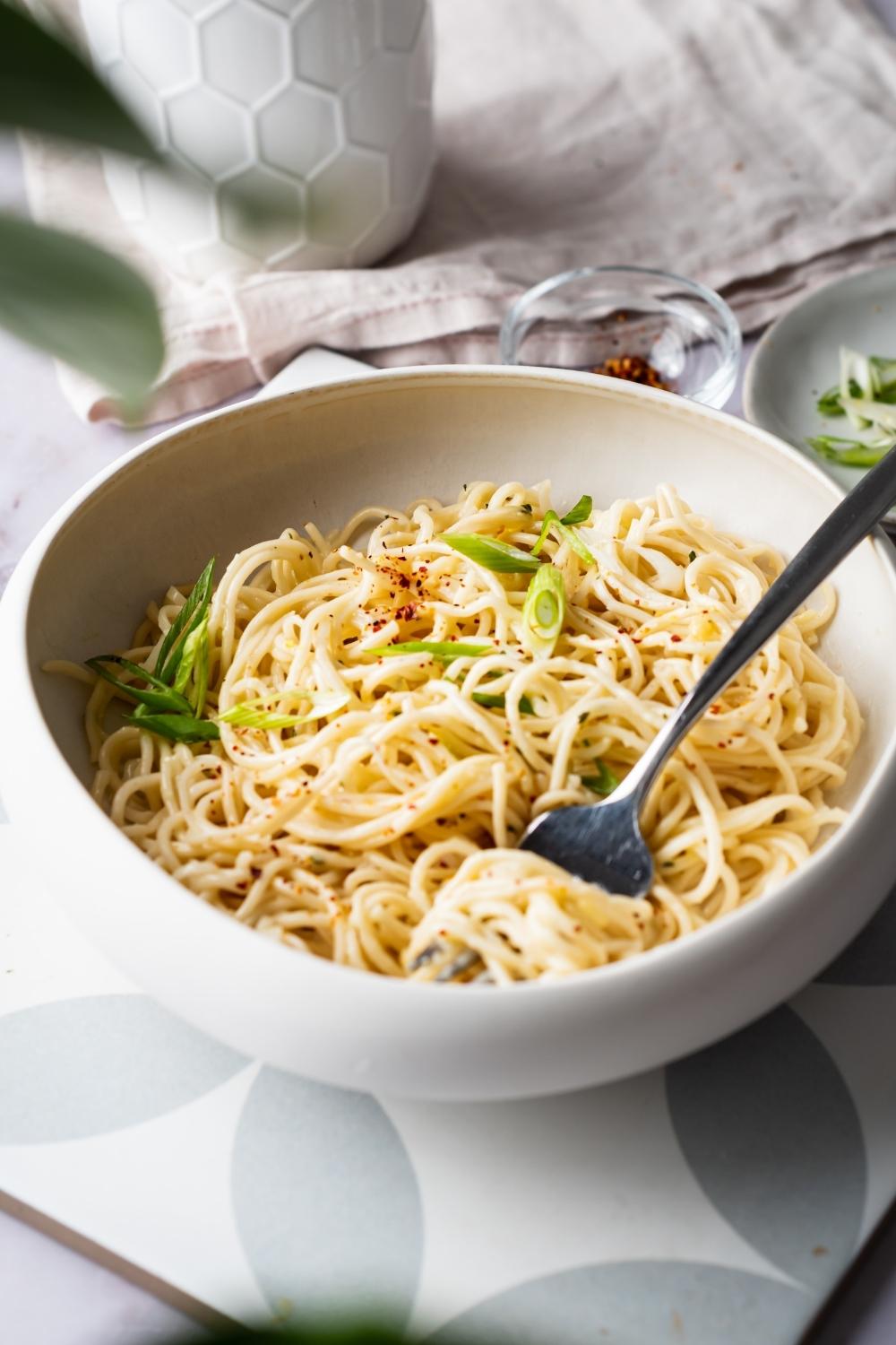 cheesy ramen garnished with green onions