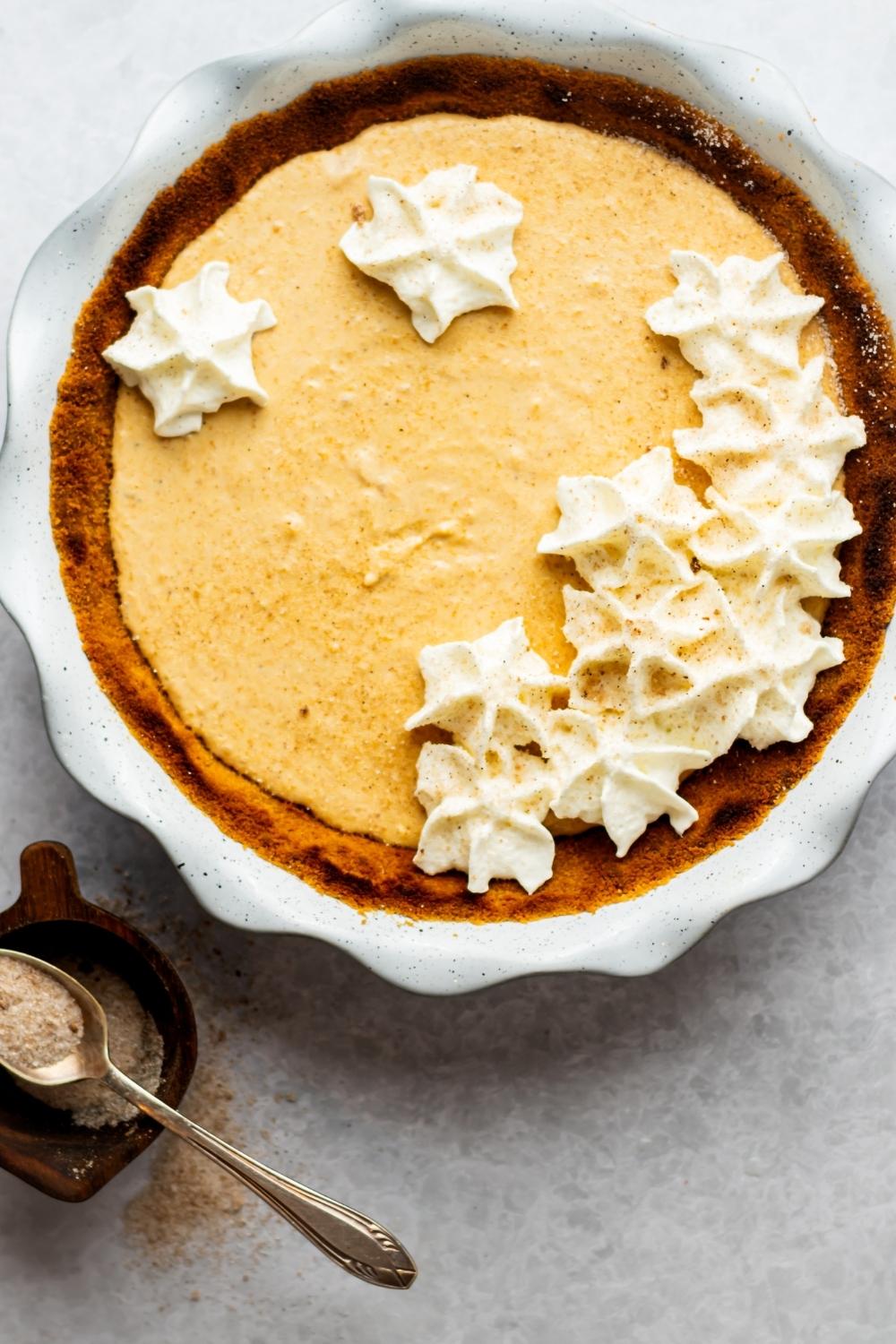 A no bake pumpkin pie in a white pie dish.