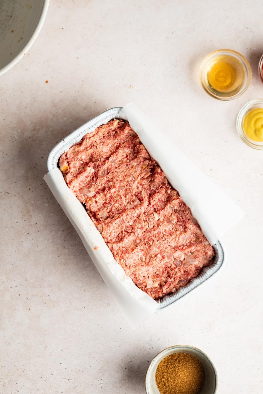 raw ham loaf in a loaf pan