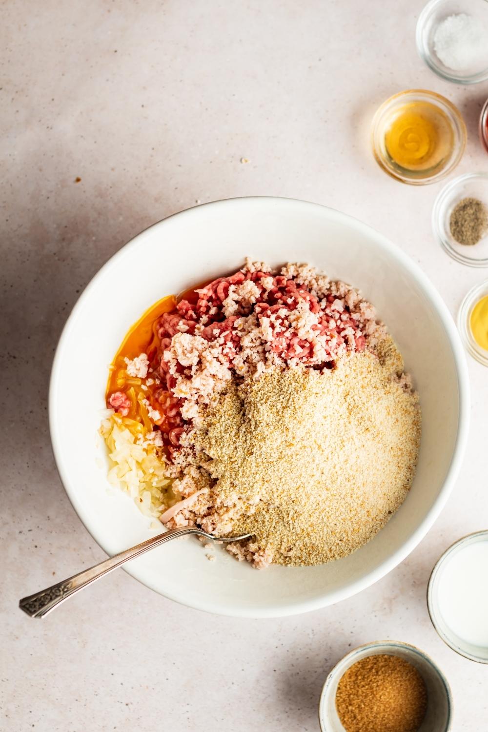 breadcrumbs, ground meat, and seasonings in a bowl