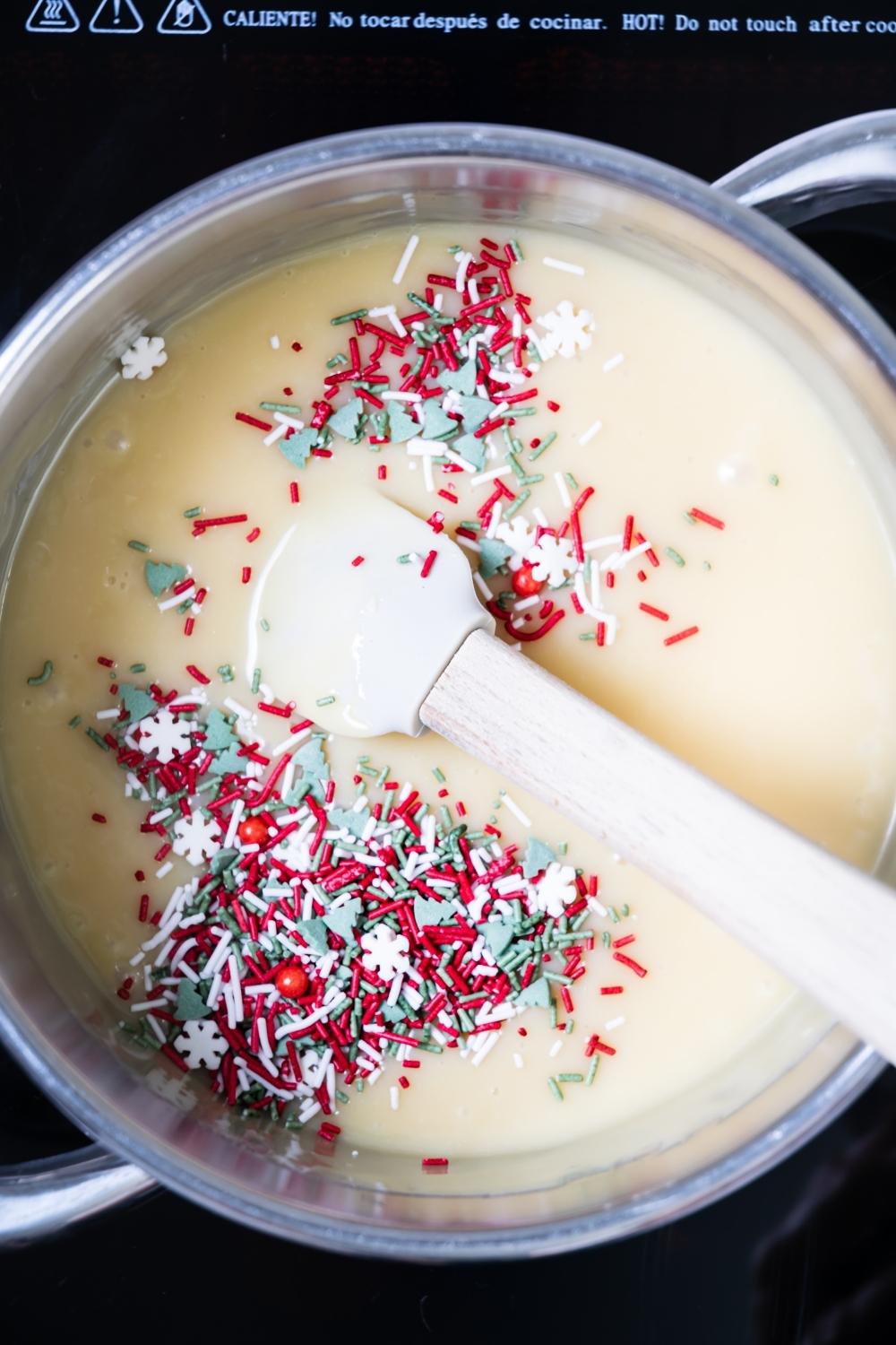 sugar cookie batter in a pan with christmas sprinkles