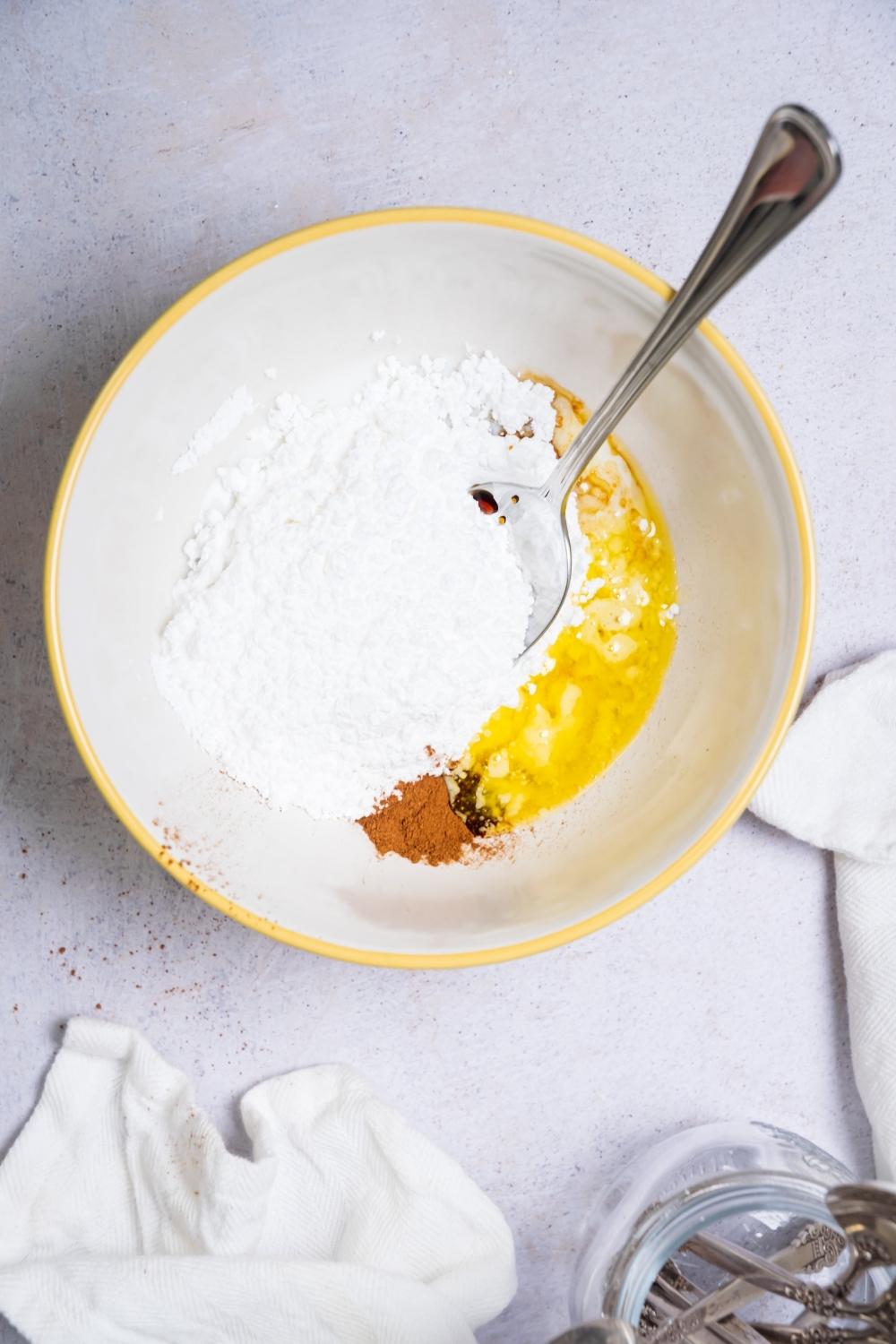 Flour and an egg in a bowl with a spoon in it,