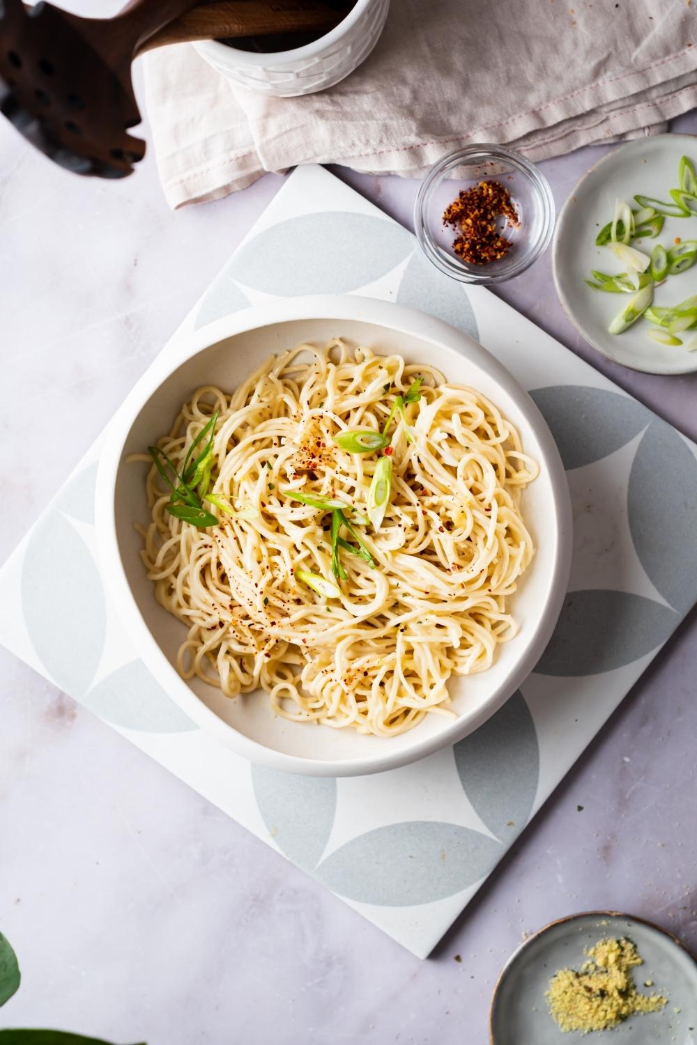 flat lay of cheesy ramen with green onions