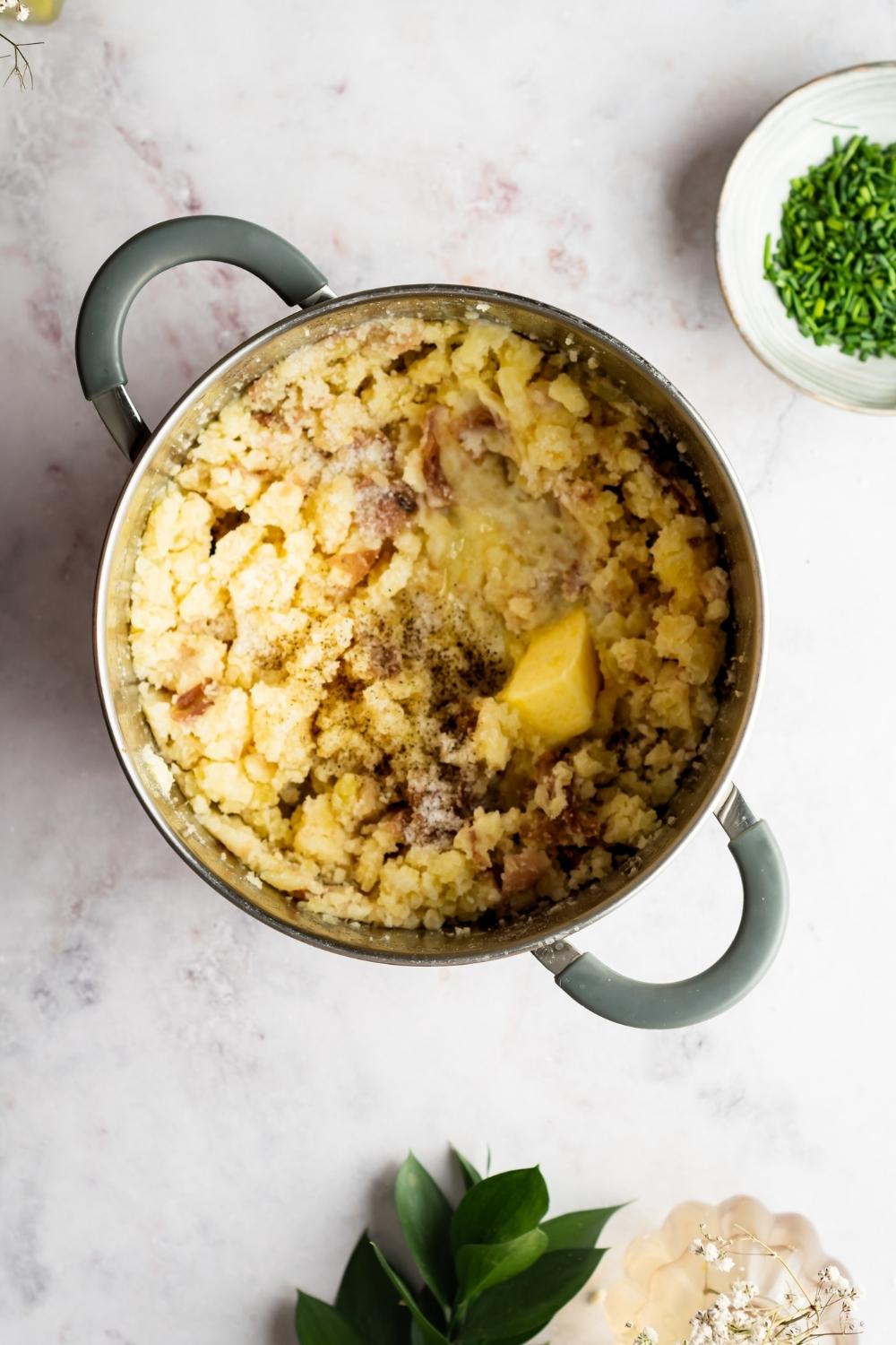 Redskin mashed potatoes with melted butter and part of the stick of butter in the potatoes.