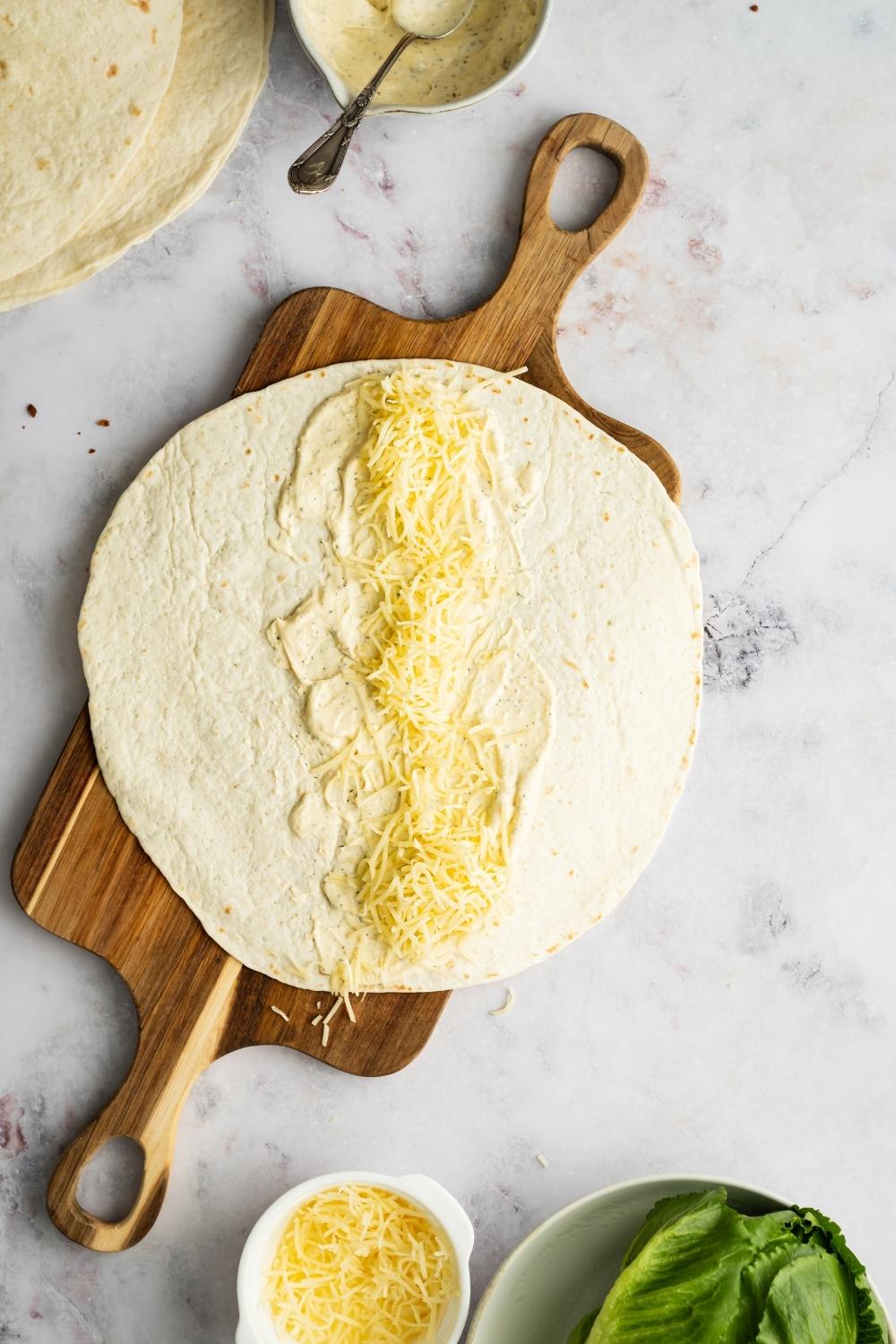 flour tortilla layered with ranch dressing and shredded cheese