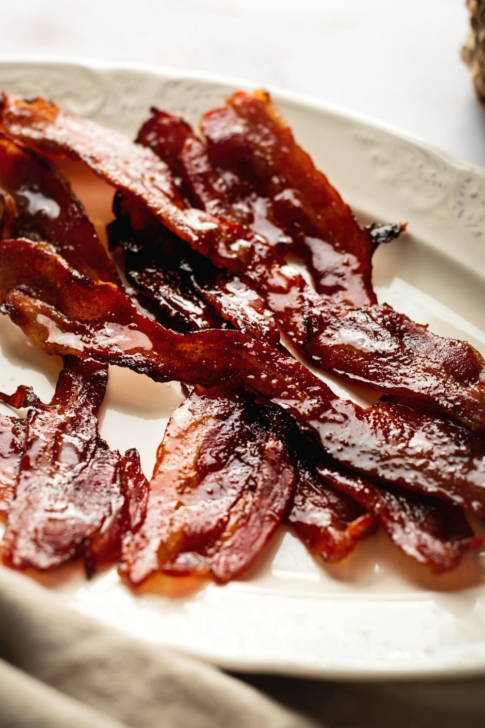 Slices of million Dollar bacon on a white plate.