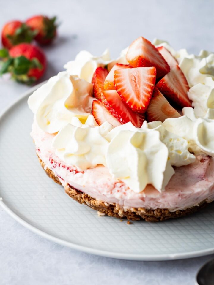 Part of a no bake strawberry pie on a plate.