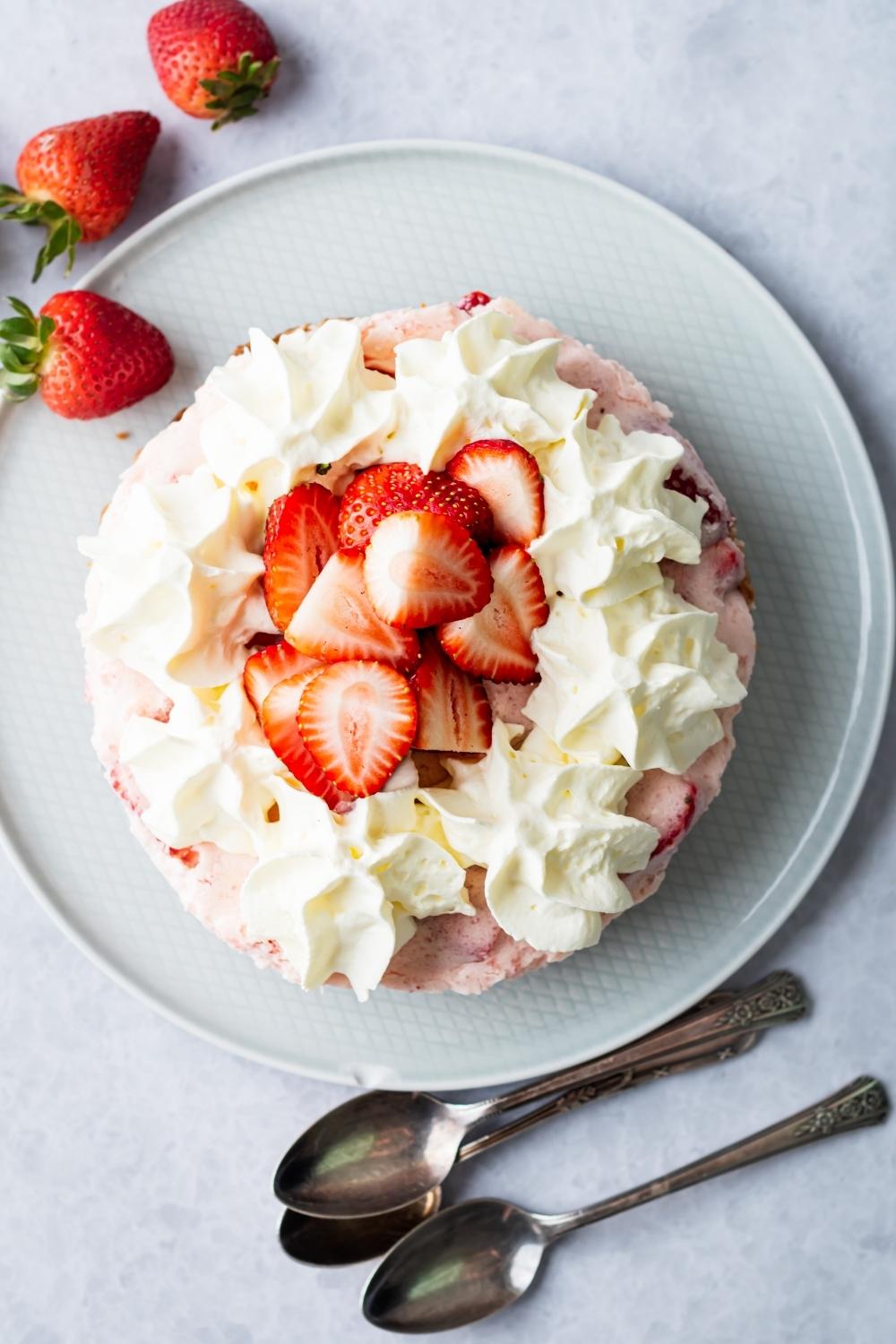 A no bake strawberry pie on a grey plate.