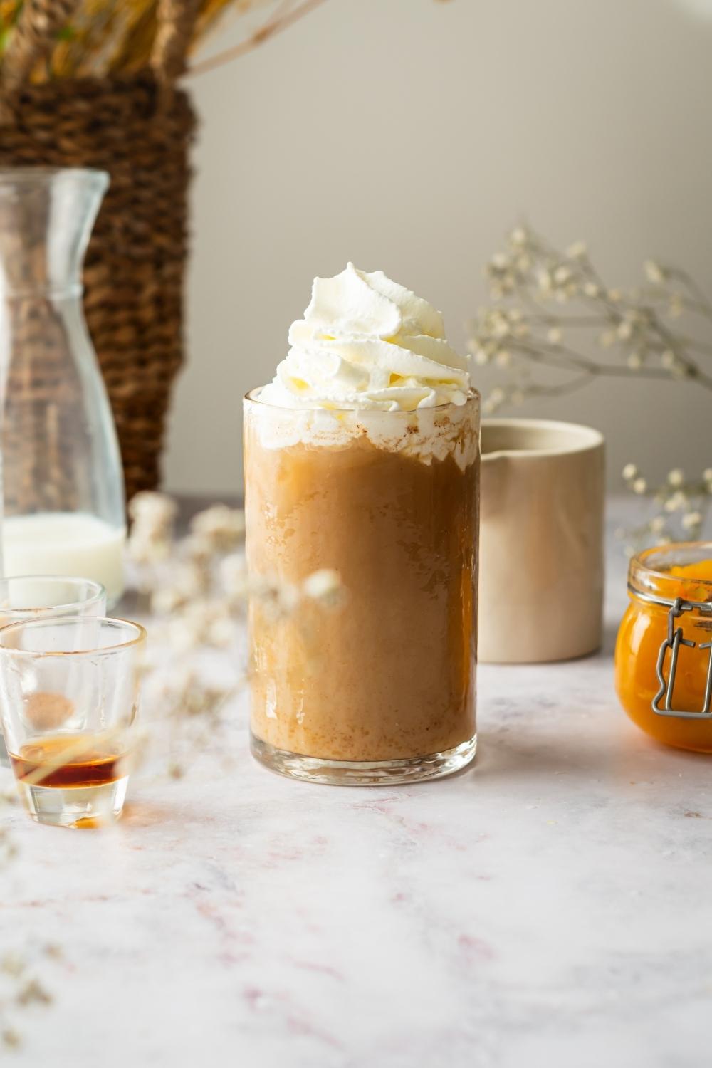 Pumpkin cream cold brew with whipped cream on top in a glass.
