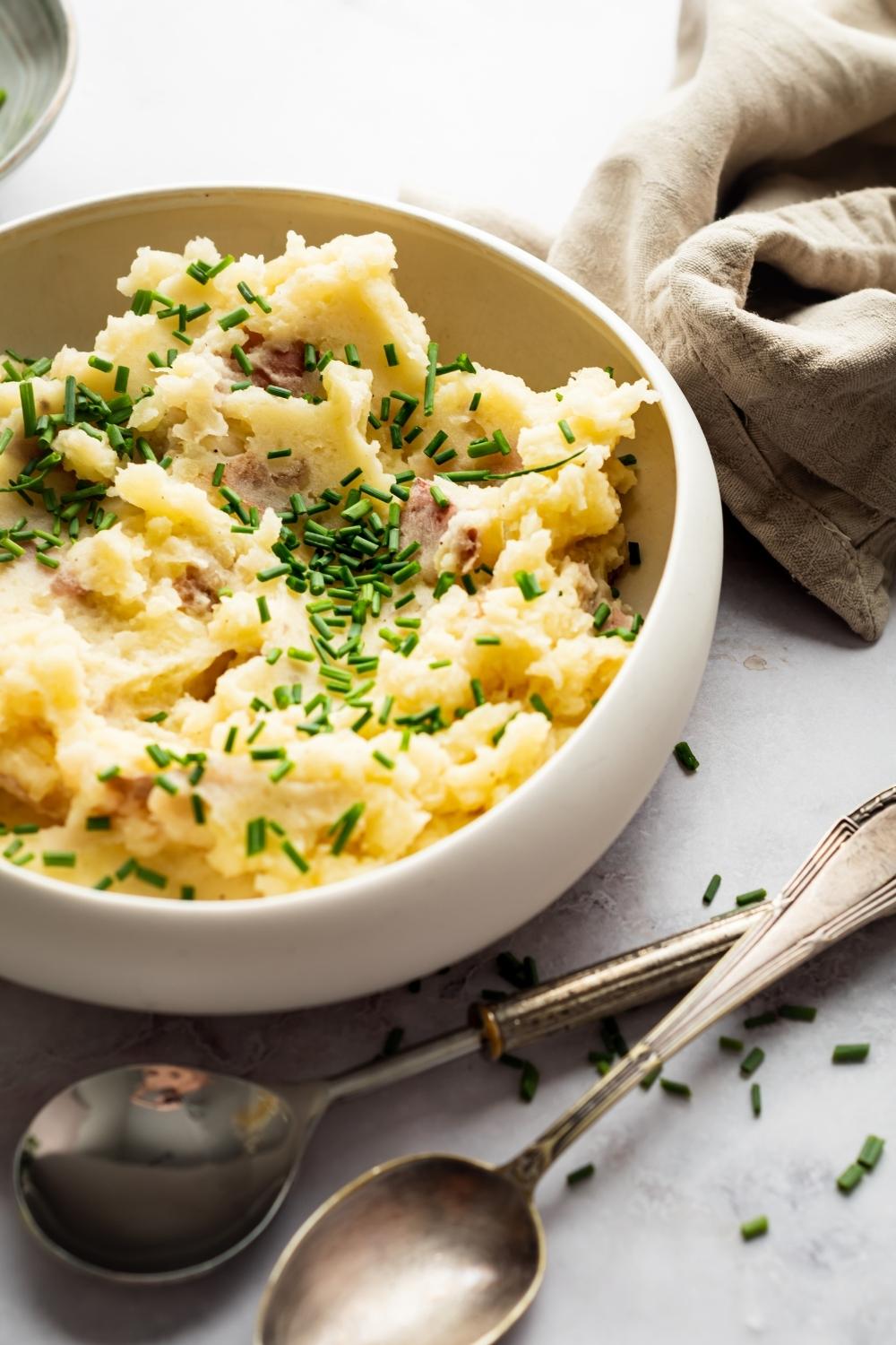 Part of a white bowl that has Redskin mashed potatoes in it.