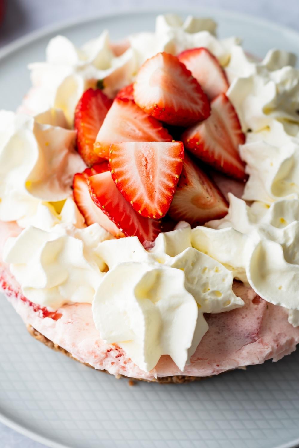 Part of a no bake strawberry pie on a plate.