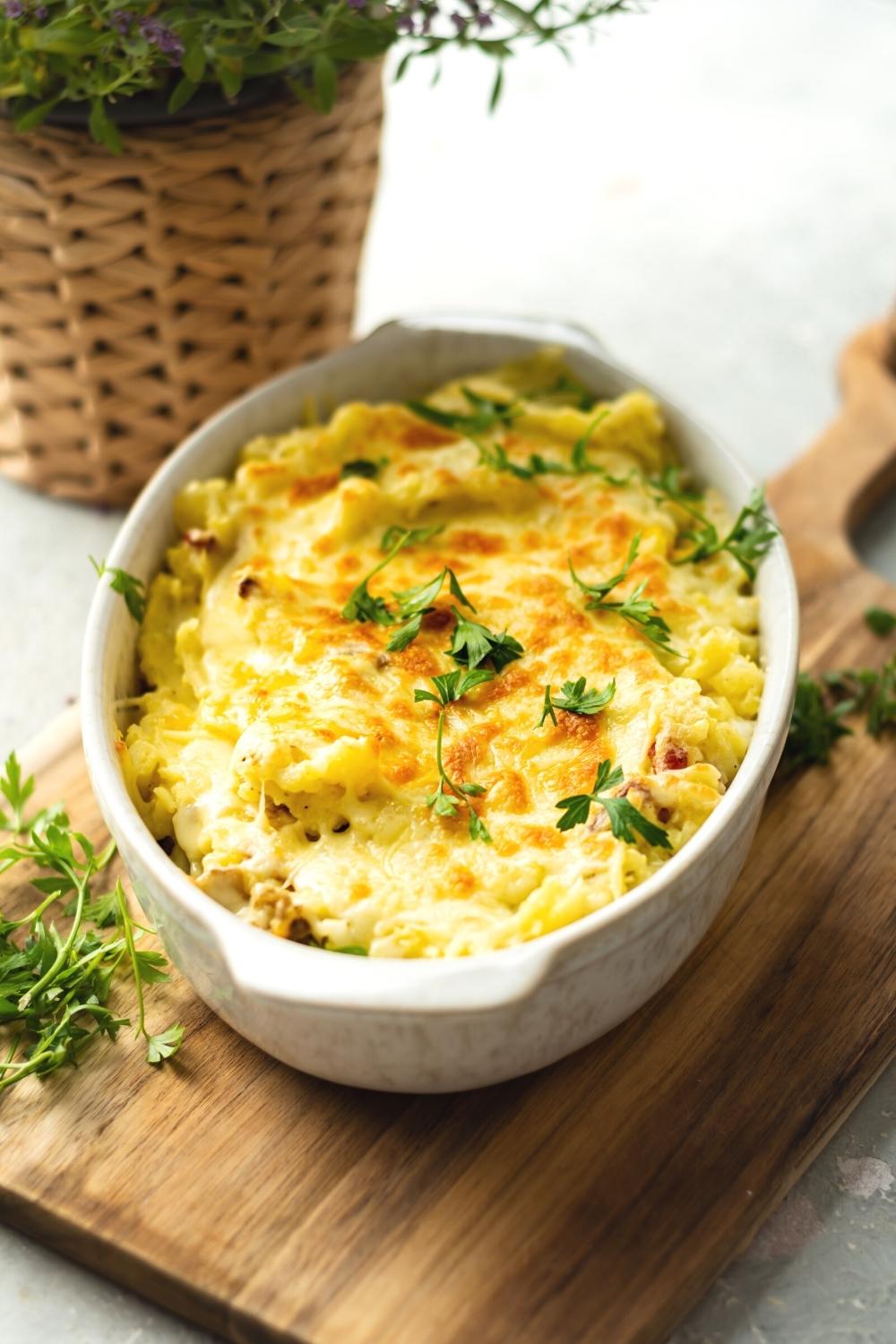 A casserole dish that is filled with twice baked mashed potatoes.