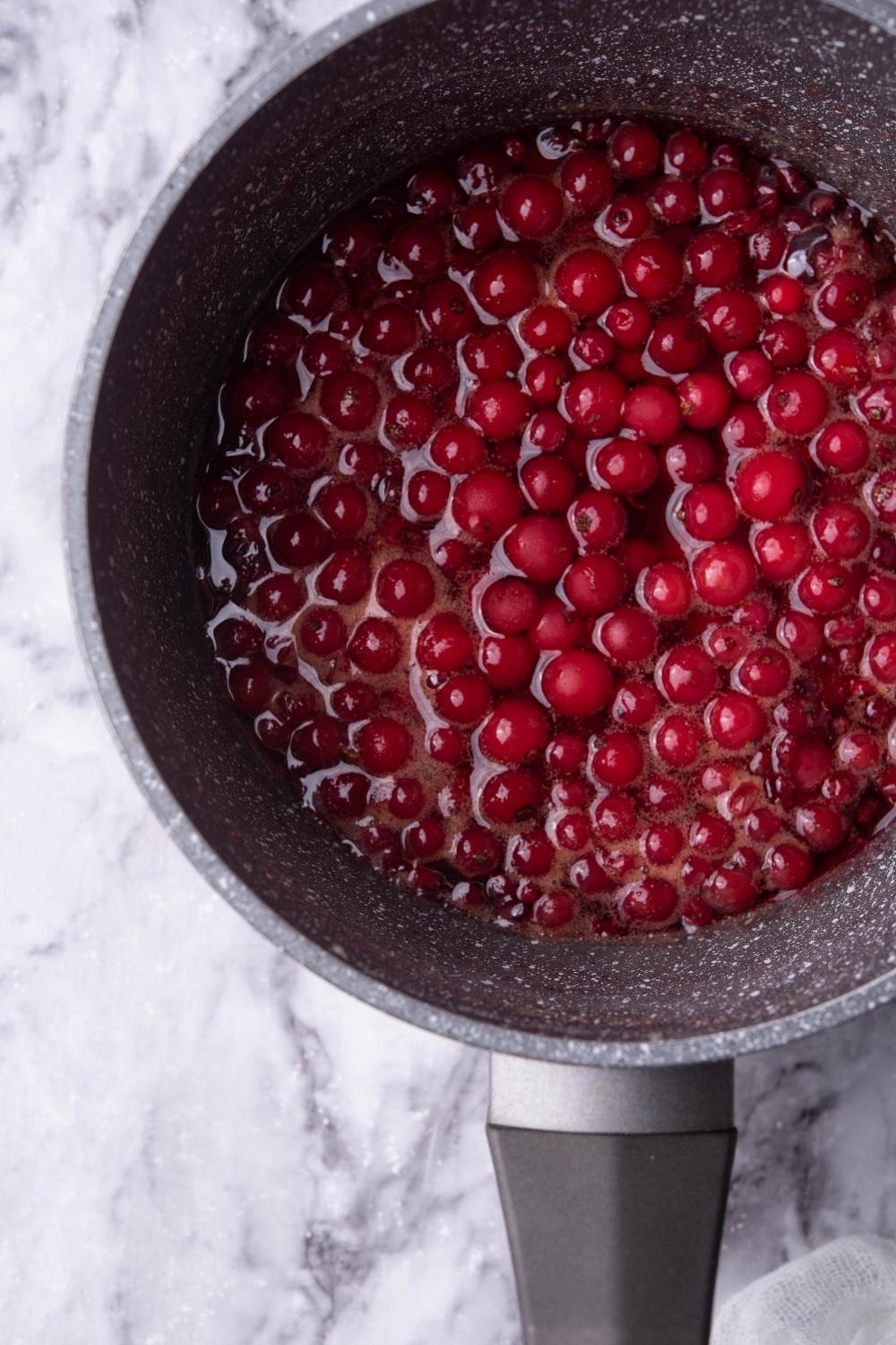 A close-up of a saucepan with homemade cranberry sauce in it.